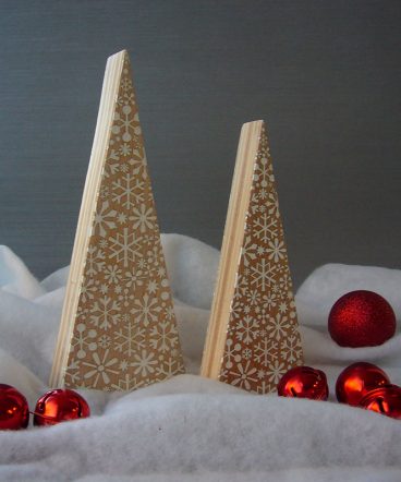 dos árboles de navidad de madera maciza natural con forma de triángulos alargados, grabados con copos de nieve pintados de blanco