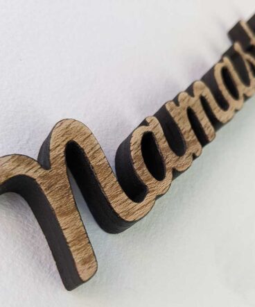 detalle de palabra namasté de madera envejecida sobre fondo blanco