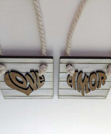 Pequeño tablero color blanco con la palabra LOVE de roble en el centro en relieve y con forma de corazón